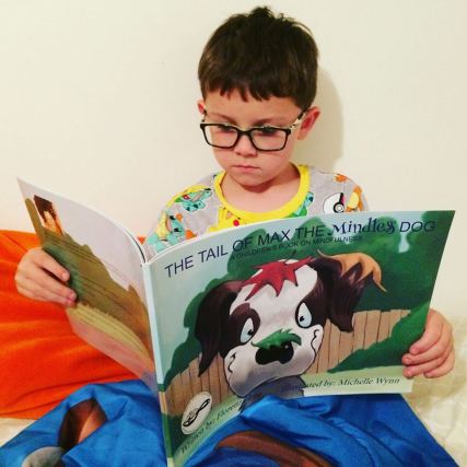 boy with glasses reading The Tail of Max the Mindless Dog by Florenza Lee